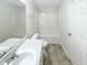 Well-lit bathroom with a shower-tub combo, modern fixtures, and neutral-toned tile flooring at 1628 Beacon Village Dr, Raleigh, NC 27604