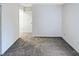 Bedroom featuring neutral carpet, white walls, and a hallway or doorway in view at 1628 Beacon Village Dr, Raleigh, NC 27604
