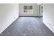 Bedroom features neutral carpet, a bright window, and a closet with sliding mirrored doors at 1628 Beacon Village Dr, Raleigh, NC 27604