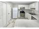 Efficient kitchen with white cabinetry, stainless steel appliances, and ample counter space at 1628 Beacon Village Dr, Raleigh, NC 27604