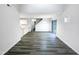Open concept living area with wood-look floors, lots of light and an adjacent kitchen at 1628 Beacon Village Dr, Raleigh, NC 27604