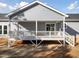 View of the back porch showing the gray siding and access to the house at 1915 Lambert Rd, Graham, NC 27253