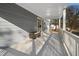 Covered back porch with neutral siding and a wood bench along the side at 1915 Lambert Rd, Graham, NC 27253