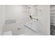 Bright bathroom featuring double vanity, gold accents, and marble-like flooring at 1915 Lambert Rd, Graham, NC 27253