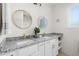Bright bathroom featuring double vanity, gold accents, and granite countertop at 1915 Lambert Rd, Graham, NC 27253