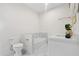 Bright bathroom showcasing a toilet, tub, and marble-like floor at 1915 Lambert Rd, Graham, NC 27253