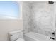 Bathroom featuring bathtub with black hardware and white tiled wall at 1915 Lambert Rd, Graham, NC 27253