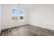 Well-lit bedroom featuring sleek grey flooring and a large window at 1915 Lambert Rd, Graham, NC 27253