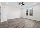 A bright and airy bedroom with light vinyl floors, neutral walls, a ceiling fan, and a window at 1915 Lambert Rd, Graham, NC 27253