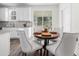 Bright dining area with round table, upholstered chairs, a sliding glass door and a large window at 1915 Lambert Rd, Graham, NC 27253