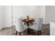 Dining area with a round table, upholstered chairs, hardwood floors, and neutral colors at 1915 Lambert Rd, Graham, NC 27253