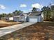 Aerial view of a single-story home with blue siding, a covered porch, and an attached garage at 1915 Lambert Rd, Graham, NC 27253