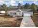 Aerial view of a single-story home featuring blue siding, a porch, and a long driveway at 1915 Lambert Rd, Graham, NC 27253