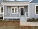 Inviting front porch with gray siding and a welcoming entrance at 1915 Lambert Rd, Graham, NC 27253