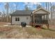 Backyard featuring a screened porch with furniture and a classic outdoor grill at 2482 Golden Forest Dr, Franklinton, NC 27525