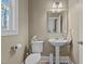 Cozy half-bathroom with modern sink, toilet, mirror, and lighting at 2482 Golden Forest Dr, Franklinton, NC 27525