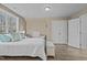 Spacious bedroom with wood-look floors, large window, and convenient closet space at 2482 Golden Forest Dr, Franklinton, NC 27525