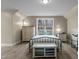 Charming bedroom with wood-look floors, large window, and neutral wall color at 2482 Golden Forest Dr, Franklinton, NC 27525