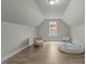 Inviting bonus room with stylish chair, decorative window, and comfortable beanbag for relaxation at 2482 Golden Forest Dr, Franklinton, NC 27525