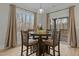 Dining area with a round wooden table set for four people and large windows at 2482 Golden Forest Dr, Franklinton, NC 27525
