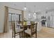 Dining area with a round table open to the kitchen and with access to the screened porch at 2482 Golden Forest Dr, Franklinton, NC 27525