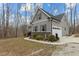 Well-maintained gray home exterior featuring an attached garage and tasteful landscaping at 2482 Golden Forest Dr, Franklinton, NC 27525