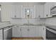 Bright white kitchen featuring stainless steel appliances, undermount sink, and stone countertops at 2482 Golden Forest Dr, Franklinton, NC 27525