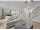 Open-concept living room featuring a staircase, access to the kitchen and light wood-look flooring at 2482 Golden Forest Dr, Franklinton, NC 27525