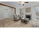 Bright living room with a fireplace, ceiling fan, and modern flooring at 2482 Golden Forest Dr, Franklinton, NC 27525