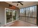 Covered and screened-in porch featuring a ceiling fan, and backyard wooded views at 2482 Golden Forest Dr, Franklinton, NC 27525