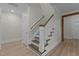 Well-lit staircase with wooden rails and decorative treads at 2482 Golden Forest Dr, Franklinton, NC 27525