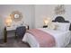 Inviting bedroom features plush bedding, decorative pillows, and a sunburst mirror over the writing desk at 249 Beacon Dr, Pittsboro, NC 27312