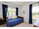 Comfortable bedroom with blue accents features natural light from two windows with dark blue curtains at 249 Beacon Dr, Pittsboro, NC 27312
