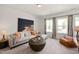 Comfortable living room with a sectional sofa, natural light, and art decor at 249 Beacon Dr, Pittsboro, NC 27312