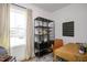 Well-lit office space with a large window, desk, and modern shelving for organization at 249 Beacon Dr, Pittsboro, NC 27312
