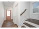 Inviting entryway with wood-look flooring, white trim, and a pink front door at 257 Beacon Dr, Pittsboro, NC 27312