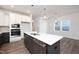 Stylish kitchen features white cabinets, gray island, stainless steel appliances, and pendant lighting at 257 Beacon Dr, Pittsboro, NC 27312
