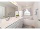 Bright bathroom boasts a soaking tub, dual sink vanity, and decorative mirrors at 306 Brier Summit Pl, Durham, NC 27703
