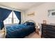 Comfortable bedroom features modern decor, carpet, and a bright window with blue curtains at 306 Brier Summit Pl, Durham, NC 27703