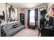 Cozy bedroom featuring an exercise machine, comfortable sofa bed, and a desk in a naturally lit space at 306 Brier Summit Pl, Durham, NC 27703