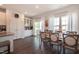 Sunlit dining room with seating for eight, accented by white cabinets and sliding door access to the outdoors at 306 Brier Summit Pl, Durham, NC 27703