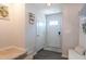 Inviting entryway showcasing a front door with a window and access to a closet and staircase at 306 Brier Summit Pl, Durham, NC 27703