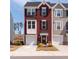Charming three-story townhouse showcasing beautiful curb appeal and attached one-car garage at 306 Brier Summit Pl, Durham, NC 27703