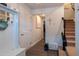 Hallway featuring neutral colors, a coat rack with a luggage piece, and stairs leading to the upper level at 306 Brier Summit Pl, Durham, NC 27703