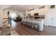 Open-concept kitchen features granite island with seating and white cabinets, flowing into an adjacent living room area at 306 Brier Summit Pl, Durham, NC 27703