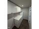 Functional kitchenette with white cabinets, stainless steel appliances, and sleek countertops at 306 Brier Summit Pl, Durham, NC 27703