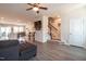 Open-concept living room showcases new floors, ceiling fan, staircase, and flow into the dining room at 306 Brier Summit Pl, Durham, NC 27703