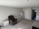 Spacious living room area with neutral carpeting and walls, plus chair and furniture at 306 Brier Summit Pl, Durham, NC 27703
