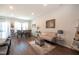Open living space featuring modern furniture and decor, with wood floors and large windows providing ample natural light at 306 Brier Summit Pl, Durham, NC 27703