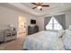 Comfortable main bedroom features a ceiling fan, ensuite bathroom, plush carpet, and lots of light at 306 Brier Summit Pl, Durham, NC 27703
